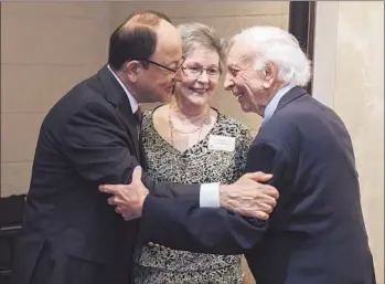  ?? Thomas Meredith For The Times ?? USC PRESIDENT C. L. Max Nikias, left, greets 1951USC alumnus Robert Bancroft and his wife, Karen, at a fundraisin­g event in Austin, part of Nikias’ tour through Texas to woo potential donors.