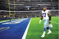  ?? (Smiley N. Pool/the Dallas Morning NEWS/TNS) ?? Dallas Cowboys offensive tackle Tyron Smith (77) leaves the field Jan. 14 after a loss to the Green Bay Packers in an NFL wild-card playoff game in Arlington, Texas.