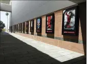  ?? CHRIS PIZZELLO, FILE - THE ASSOCIATED PRESS ?? Posters for upcoming movies are displayed in an empty corridor at the currently closed AMC Burbank Town Center 8 movie theaters complex on April 29, in Burbank, Calif.