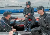  ??  ?? Ray Davies, Glenn Ashby and Louis Sinclair discuss progress during a break in Team New Zealand testing of their AC75 in Auckland.