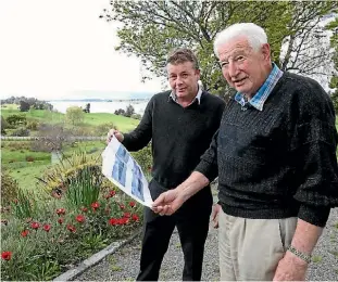  ?? PHOTO: MARION VAN DIJK/ FAIRFAX NZ ?? Dr Tim Phillips, left, and Dale Vercoe on site with draft concept drawings of a proposed health centre.