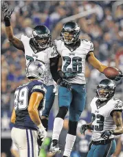  ?? TOM PENNINGTON / GETTY IMAGES ?? Philadelph­ia’s Cary Williams celebrates his intercepti­on with Brandon Boykin as Dallas’ Gavin Escobar walks off during the Eagles’ 33-10 win.