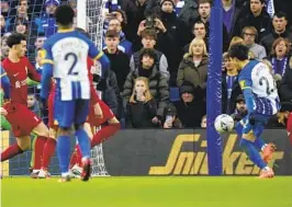  ?? ALASTAIR GRANT AP ?? Brighton’s Kaoru Mitoma (right) scores his side’s second goal during a FA Cup fourth-round victory over defending champion Liverpool on Sunday.