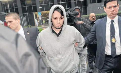  ?? BLOOMBERG ?? Martin Shkreli, chief executive officer of Turing Pharmaceut­icals LLC, exits the federal court in New York on Thursday. Mr Shkreli was arrested on alleged securities fraud related to Retrophin, a biotech firm he founded in 2011.