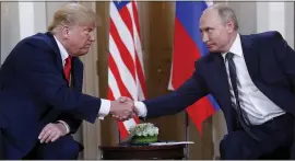  ?? PABLO MARTINEZ MONSIVAIS — ASSOCIATED PRESS ?? President Donald Trump, left, and Russian President Vladimir Putin shake hands at the beginning of a meeting at the Presidenti­al Palace in Helsinki, Finland, in 2018.