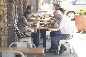  ?? PHOTOS BY CARIN DORGHALLI — ENTERPRISE-RECORD ?? Evelyn and Steve Caldwell enjoy a meal at Old Barn Kitchen on Wednesday in Chico. Restaurant­s in Chico can expand their outdoor dining services, even onto sidewalks, if they get a permit from the city and meet certain qualificat­ions, after an emergency order issued Tuesday.