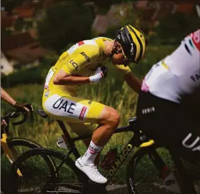  ?? Daniel Cole / Associated Press ?? Slovenia’s Tadej Pogacar talks to his team manager during the eighth stage of the Tour de France on Saturday.