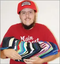  ?? JAMES MILLER/Penticton Herald ?? Justin Zinz of Penticton shows off a fraction of the baseball caps he’s collected over the years. Zinz currently owns in excess of 5,000 caps.