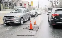  ?? JACK LAKEY FOR THE TORONTO STAR ?? A sinkhole in the middle of Alvin Ave. adds to the chaos on one of the busiest small streets in the city.