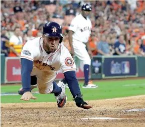  ?? AP Photo/ David J. Phillip ?? Houston Astros’ George Springer scores on teammate Alex Bregman’s hit during the seventh inning in Game 1 of an American League Division Series game against the Cleveland Indians on Friday in Houston. The Astros won, 7-2.