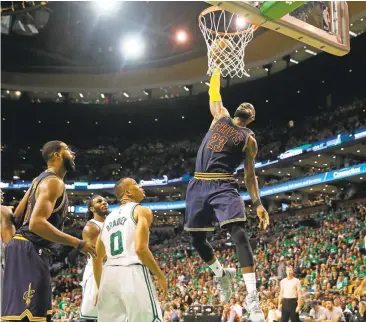  ?? ELSA/GETTY IMAGES ?? Cleveland Cavaliers superstar LeBron James dunks in a 135-102 rout of the Boston Celtics to close out the series 4-1.