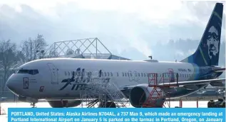  ?? — AFP ?? PORTLAND, United States: Alaska Airlines N704AL, a 737 Max 9, which made an emergency landing at Portland Internatio­nal Airport on January 5 is parked on the tarmac in Portland, Oregon, on January 23, 2024.