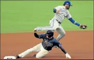  ?? MIKE EHRMANN / Getty Images ?? Rays shortstop Willy Adames, below, steals second base as Blue Jays second baseman Jonathan Villar fields an errant throw Tuesday during Game 1 of their American League wild-card series at Tropicana Field in St Petersburg, Fla.