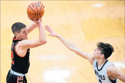  ?? KYLE TELECHAN /POST-TRIBUNE PHOTOS ?? LaPorte’s Ethan Osowski shoots over Lowell’s Cayden Vasko during their game Tuesday at Lowell.