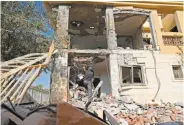  ?? Jack Guez / AFP / Getty Images ?? An Israeli soldier checks a house in Beersheba city after it was hit by a rocket fired from Gaza.