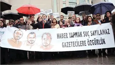  ??  ?? Journalist­s and human rights activists holding a banner that reads" Journalism is not a crime - free journalist­s" outside the main courthouse in Istanbul, Turkey in this file photo. (AP)