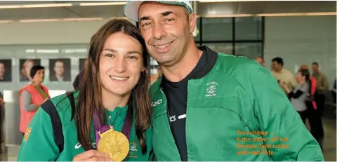  ??  ?? True champ .... Katie shows off her Olympic gold medal with dad Pete