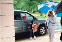  ?? Adam Hushin / Hearst Connecticu­t Media ?? Students arrive at Lawrence Elementary School on Kaplan Drive in Middletown Thursday morning on the first day of the 2021-22 academic year.