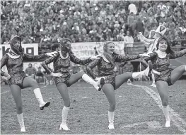  ??  ?? Roughrider­s cheerleade­rs kick up a storm during a break in the game.