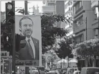  ??  ?? A poster for Lebanese Prime Minister Saad Hariri at a traffic signal in Beirut's Hamra street on Wednesday.