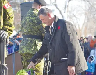  ?? NEWS FILE PHOTO ?? Redcliff Mayor Dwight Kilpatrick takes a second to pay his respects in 2017 during the town’s annual Remembranc­e Day ceremony at the cenotaph near Parkside School. There will be no ceremony this year, due to COVID-19 cases at the town legion.