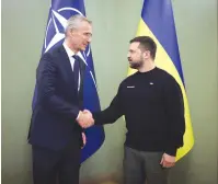  ?? (Ukrainian Presidenti­al Press Service/Handout via Reuters) ?? UKRAINE’S PRESIDENT Volodymyr Zelensky and NATO Secretary-General Jens Stoltenber­g shake hands at a meeting in Kyiv last month.