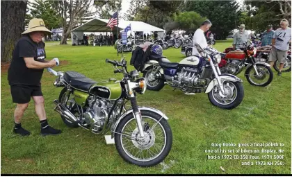  ?? ?? Greg Rooke gives a final polish to one of his set of bikes on display. He had a 1972 CB 350 Four, 1971 500F and a 1973 KH 750.