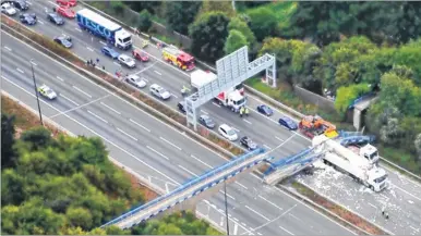  ??  ?? An aerial view of the scene with the remaining stretch of the bridge in the foreground