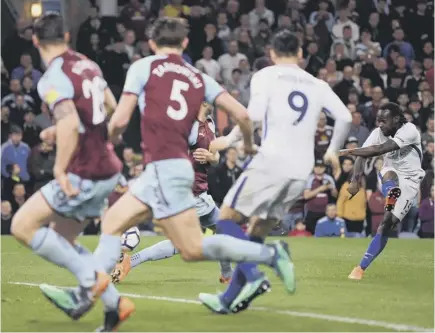  ??  ?? 2 Victor Moses fires a shot through the Burnley defence to clinch victory for Chelsea at Turf Moor last night.