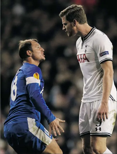  ?? — GETTY IMAGES ?? Things get fiery between Dnipro Dnipropetr­ovsk striker Roman Zozulya and Tottenham Hotspur defender Jan Vertonghen in a Champions League knockout match on Thursday. The Spurs won 3-1 to advance.