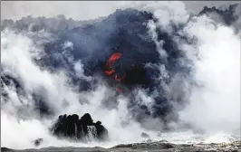  ?? MARIO TAMA / GETTY IMAGES ?? A steam plume rises as lava enters the Pacific Ocean, after flowing to the water from a Kilauea volcano fissure, on Hawaii’s Big Island on Sunday near Pahoa, Hawaii. Officials are concerned that “laze,” a dangerous product produced when hot lava hits...