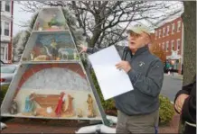  ??  ?? Rocco DeFazio, with the Friends of Little Italy, explains aspects of an Italian Christmas after the 35th annual Winter Walk for Joseph’s House and Shelter in Troy.