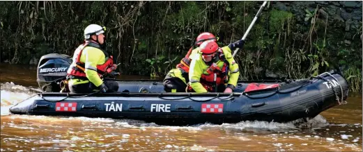  ?? ?? RACE AGAINST TIME: Firefighte­rs searching the River Cleddau at Haverfordw­est yesterday after tragedy struck a group of paddleboar­ders