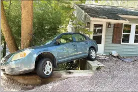  ?? PHOTO BY ROK H. HYON ?? Ida’s floodwater­s pushed this car into a home along Skippack Pike.