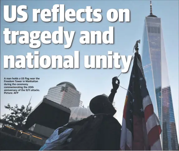  ?? Picture: AFP ?? A man holds a US flag near the Freedom Tower in Manhattan during the ceremony commemorat­ing the 20th anniversar­y of the 9/11 attacks.