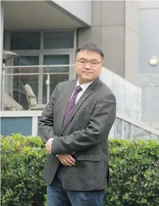  ?? MARK VAN MANEN/FILES ?? Simon Fraser University city program director Andy Yan is shown in Coal Harbour, where he has documented significan­t numbers of vacant condo units.