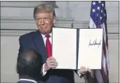  ?? ALEX BRANDON — THE ASSOCIATED PRESS ?? President Donald Trump holds a signed Constituti­on Day proclamati­on Thursday after he spoke to the White House conference on American History at the National Archives museum in Washington.