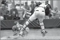  ?? NWA Democrat-Gazette/J.T. WAMPLER ?? Max Horton of Rogers slides across home plate to score under the tag of Conway’s Jack Stroth on Thursday in the Mounties’ 9-5 victory over the Wampus Cats in the first round of the Class 7A state baseball tournament in Bentonvill­e.