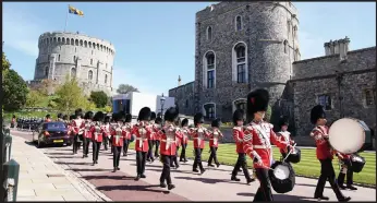  ??  ?? Members of the military arrive for the funeral of the Duke of Edinburgh in Windsor Castle
Turn over for more images