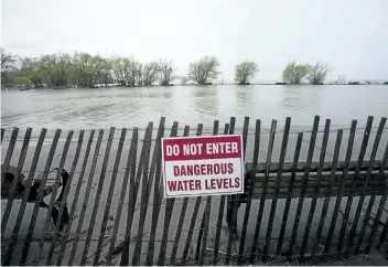  ?? PHOTOS BY JULIE JOCSAK/STANDARD STAFF ?? Last week’s heavy rains have left large portions of the piers in Port Dalhousie under water and pathways waterlogge­d.