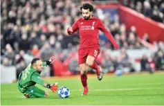  ??  ?? Napoli’s Colombian goalkeeper David Ospina (L) dives to save the ball from Liverpool’s Egyptian midfielder Mohamed Salah during the UEFA Champions League group C football match between Liverpool and Napoli at Anfield stadium in Liverpool, north west England on December 11, 2018. - AFP photo