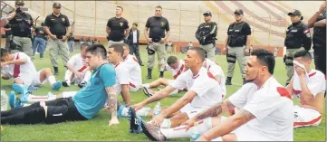  ??  ?? Inmates from the Peruvian prison of Lurigancho (playing for Peru) take a break under heavy guard, during their ‘First Inter-prison World Cup Russia 2018’ final against inmates from Chimbote prison (playing for Russia), at the Monumental stadium in...