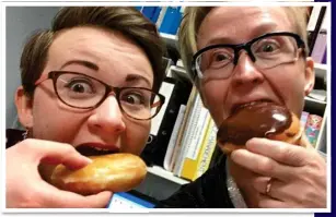  ??  ?? TUCKING IN: Two medics take advantage of the gift of free cakes