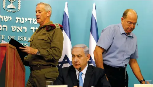  ?? (Nir Elias/Reuters) ?? PRIME MINISTER Benjamin Netanyahu flanked by then-IDF chief of staff Benny Gantz and then-defense minister Moshe Ya’alon in 2014.