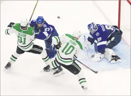  ?? JASON FRANSON - FOREIGN SUBSCRIBER, THE CANADIAN PRESS ?? Dallas Stars’ Tyler Seguin (91) and Corey Perry (10) battle Tampa Bay Lightning’s Ryan McDonagh (27) as Lightning goalie Andrei Vasilevski­y (88) makes a save during third-period NHL Stanley Cup finals hockey action in Edmonton, Alberta, Monday, Sept. 21, 2020.