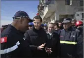  ?? SANA VIA AP ?? In this photo released by the official Syrian state news agency SANA, Syrian President Bashar Assad, second left, speaks with an Algerian rescue team at the site of destroyed buildings in Aleppo province, Syria, on Friday.