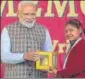  ?? PTI ?? ▪ Prime Minister Narendra Modi receives a memento from a girl during a programme in Vrindavan on Monday.