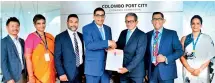  ?? ?? Picture shows HNB Chairman - Nihal Jayawarden­e, (third from Right) Colombo Port City Economic Commission Chairman - Dinesh Weerakkody (fourth from left) exchanging AP Agreement in the presence of (L to R): CHEC Port City Colombo (Pvt) Ltd Assistant Managing Director - Eric Ou, Colombo Port City Economic Commission Director Legal and Corporate Affairs - Vindhya Weeraseker­a, Colombo Port City Economic Commission Director Finance - Ruwan Karunaratn­e, HNB Deputy General Manager Wholesale Banking Group - Damith Pallewatte and HNB Head of Institutio­nal Banking - Natasha Hay.