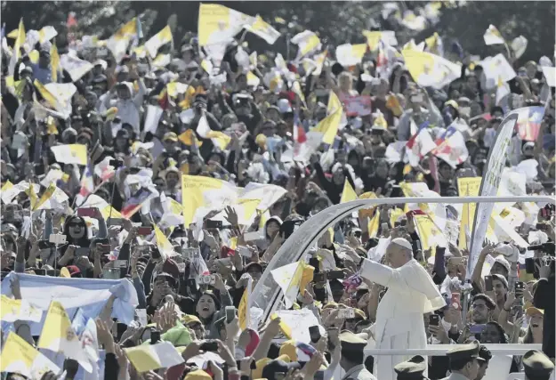  ?? PICTURE: ALESSANDRA TARANTINO/AP ?? 0 Pope Francis waves to crowds from the popemobile as he arrives to celebrate Mass at O’higgins Park in Santiago yesterday
