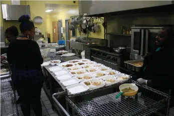  ?? (Matt Hutcheson/News-Times) ?? Workers prepare dinner in the Salvation Army Red Shield Diner on Wednesday. The diner has seen increased demand recently, serving over 3,000 more meals in May 2022 versus May 2021.